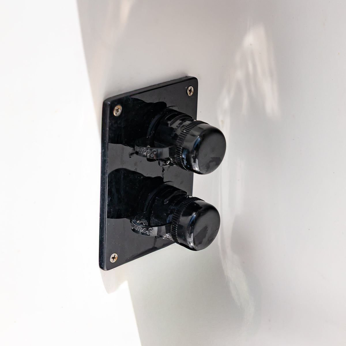 Dual black Flush Port Reroute mounted inside a boat with one cap open