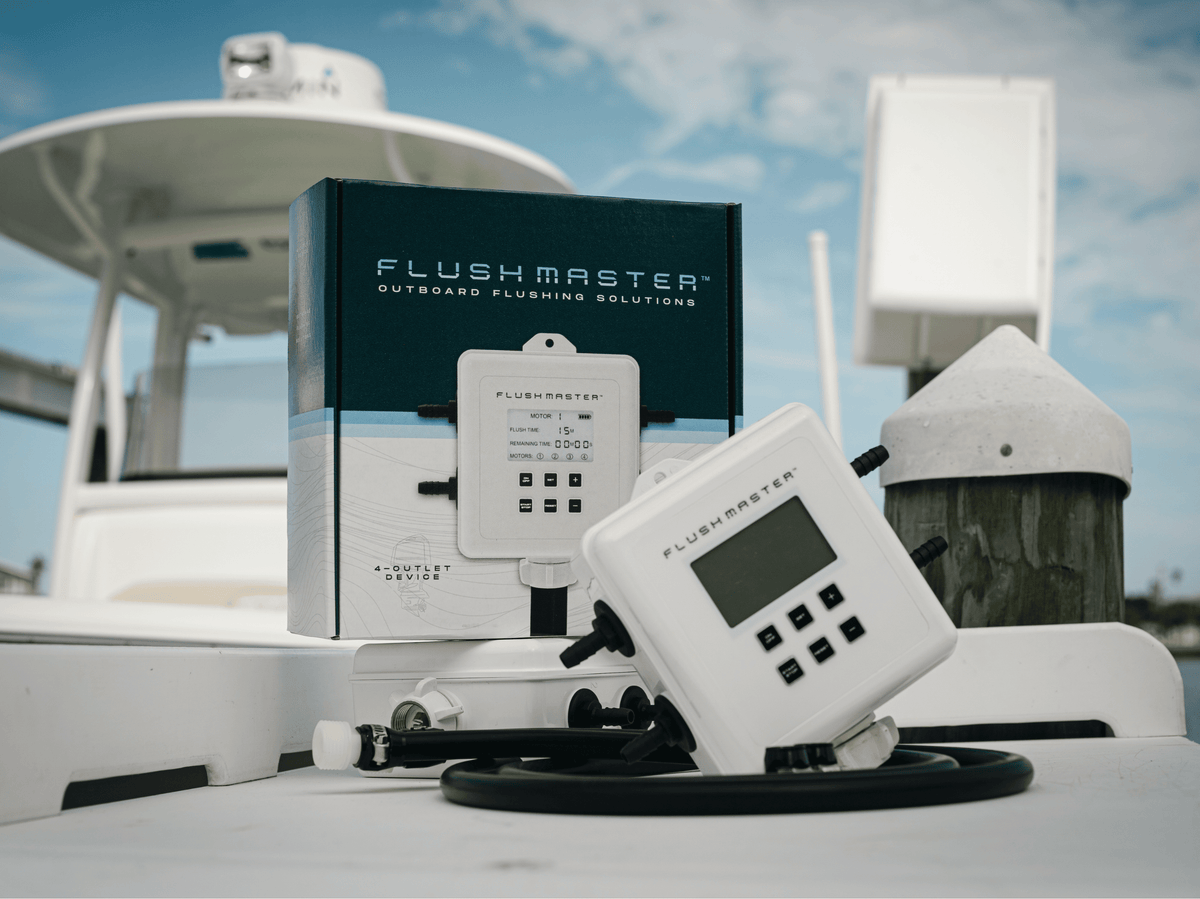Flushmaster Controllers and coiled hoses displayed with retail packaging on a boat