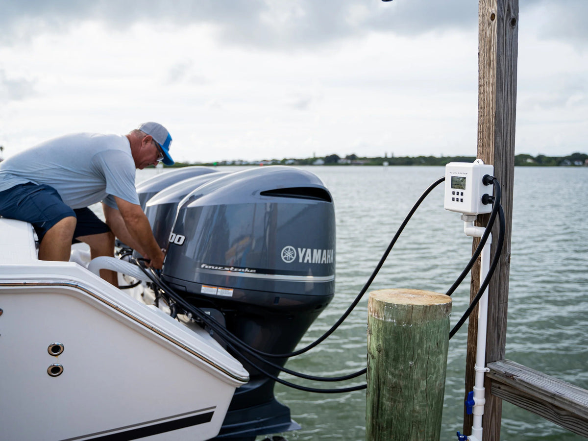Boater reaching a Yamaha flush connection beside a dock-mounted Flushmaster Controller