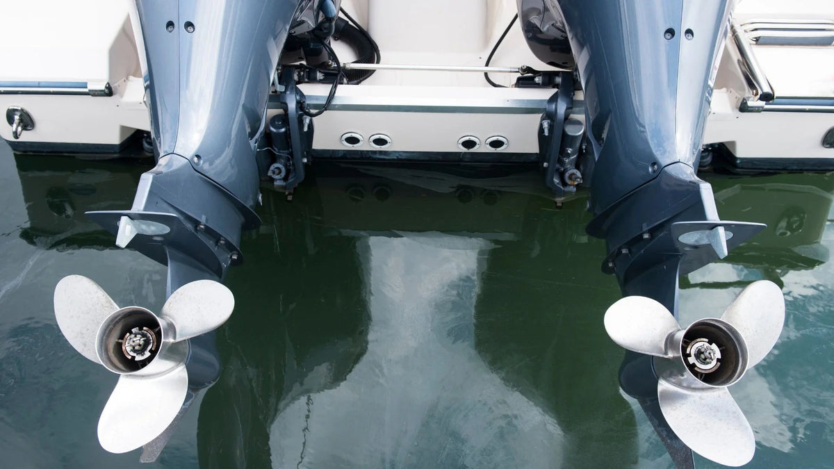 Twin outboard lower units and propellers above the water