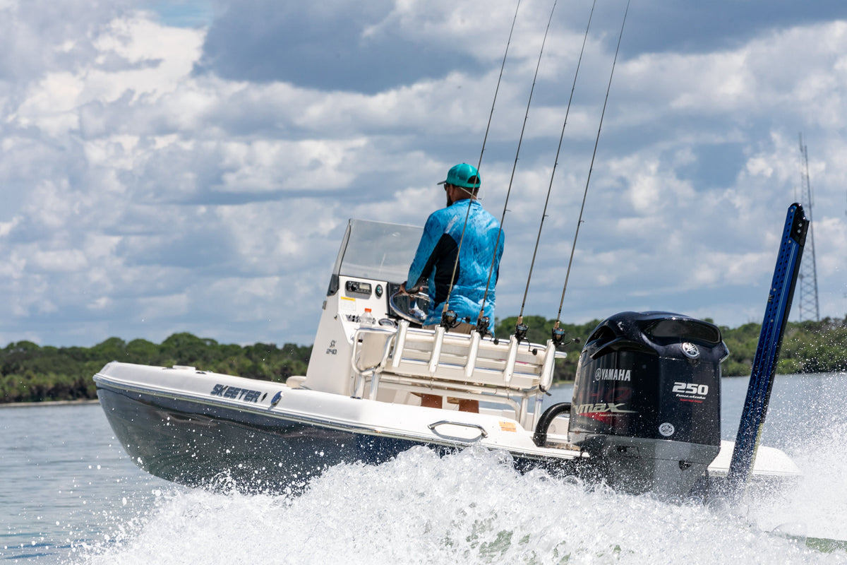 Boater at the helm of a center-console boat underway