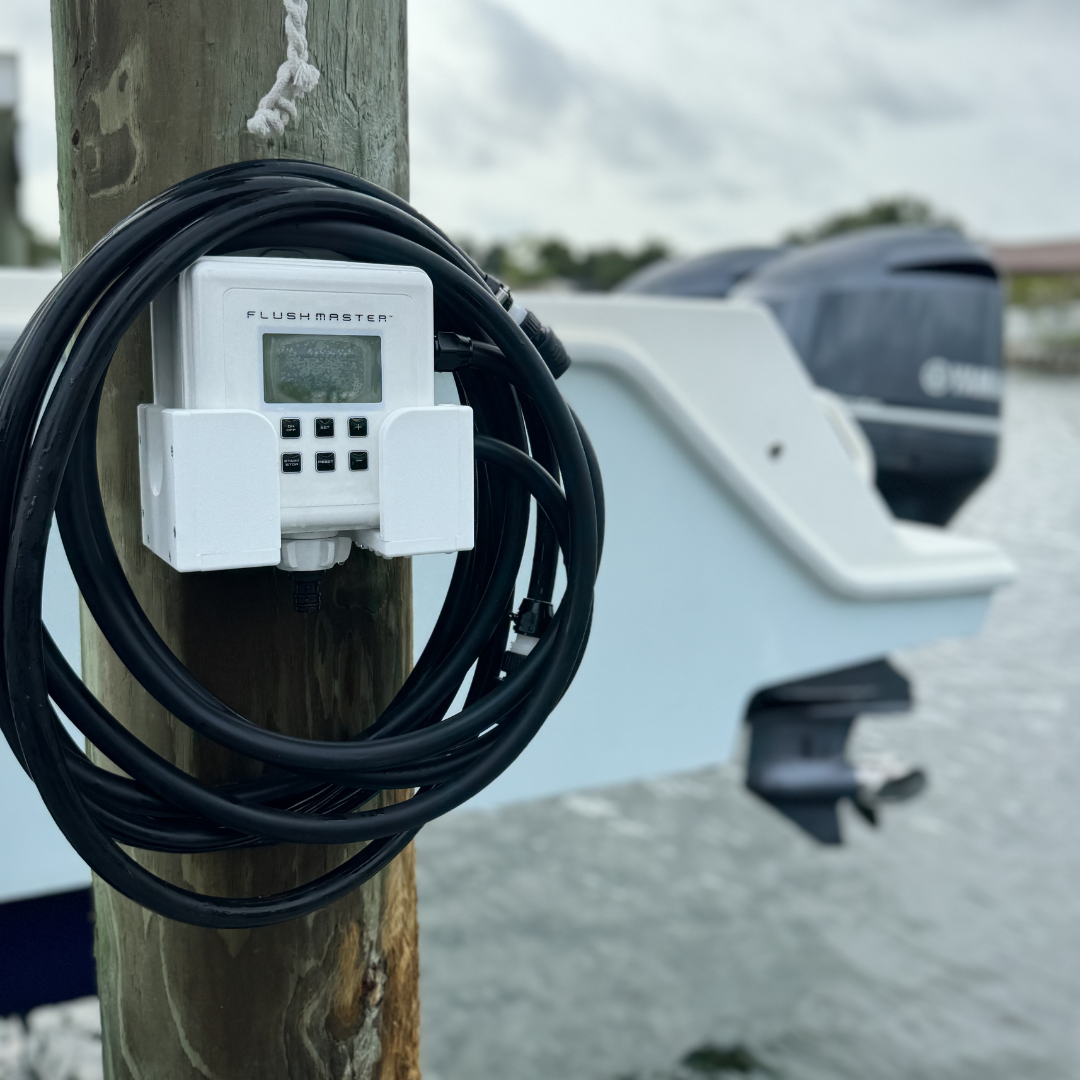 Flushmaster Controller and coiled hoses in a cradle on a dock piling