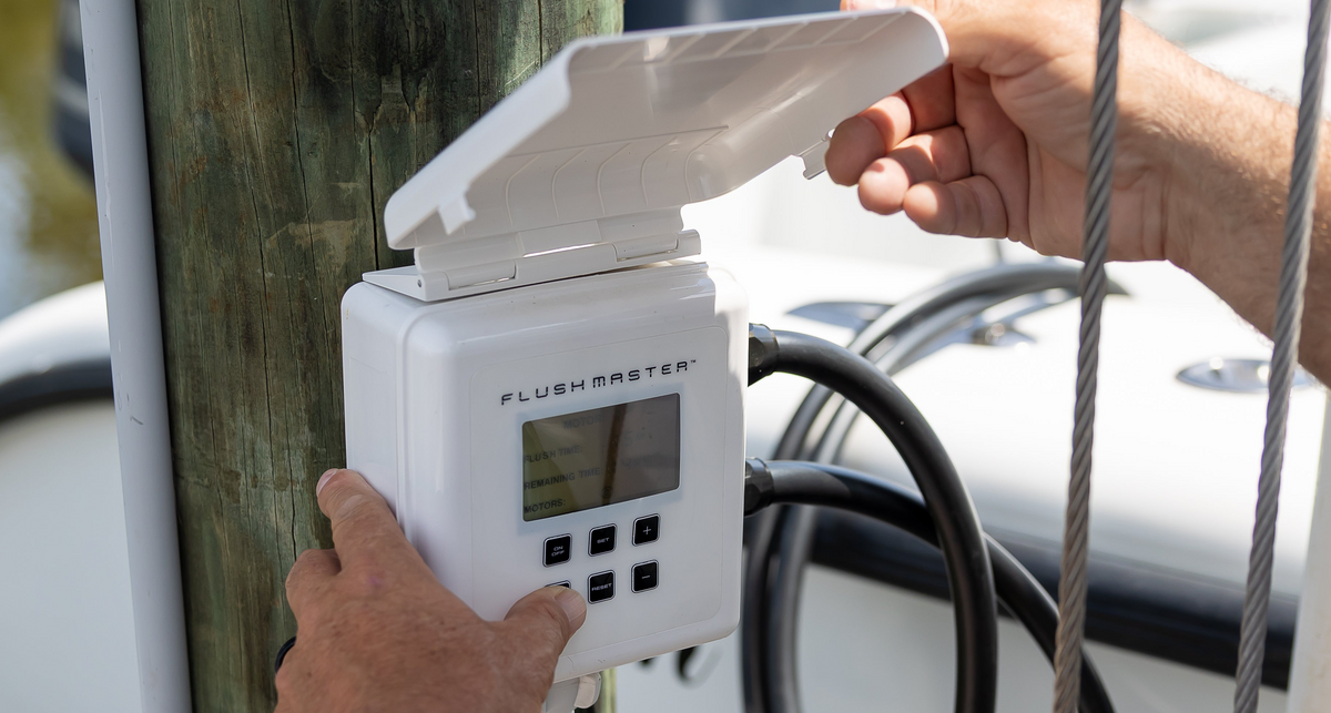 Hands opening the Suncover and using a dock-mounted Flushmaster Controller