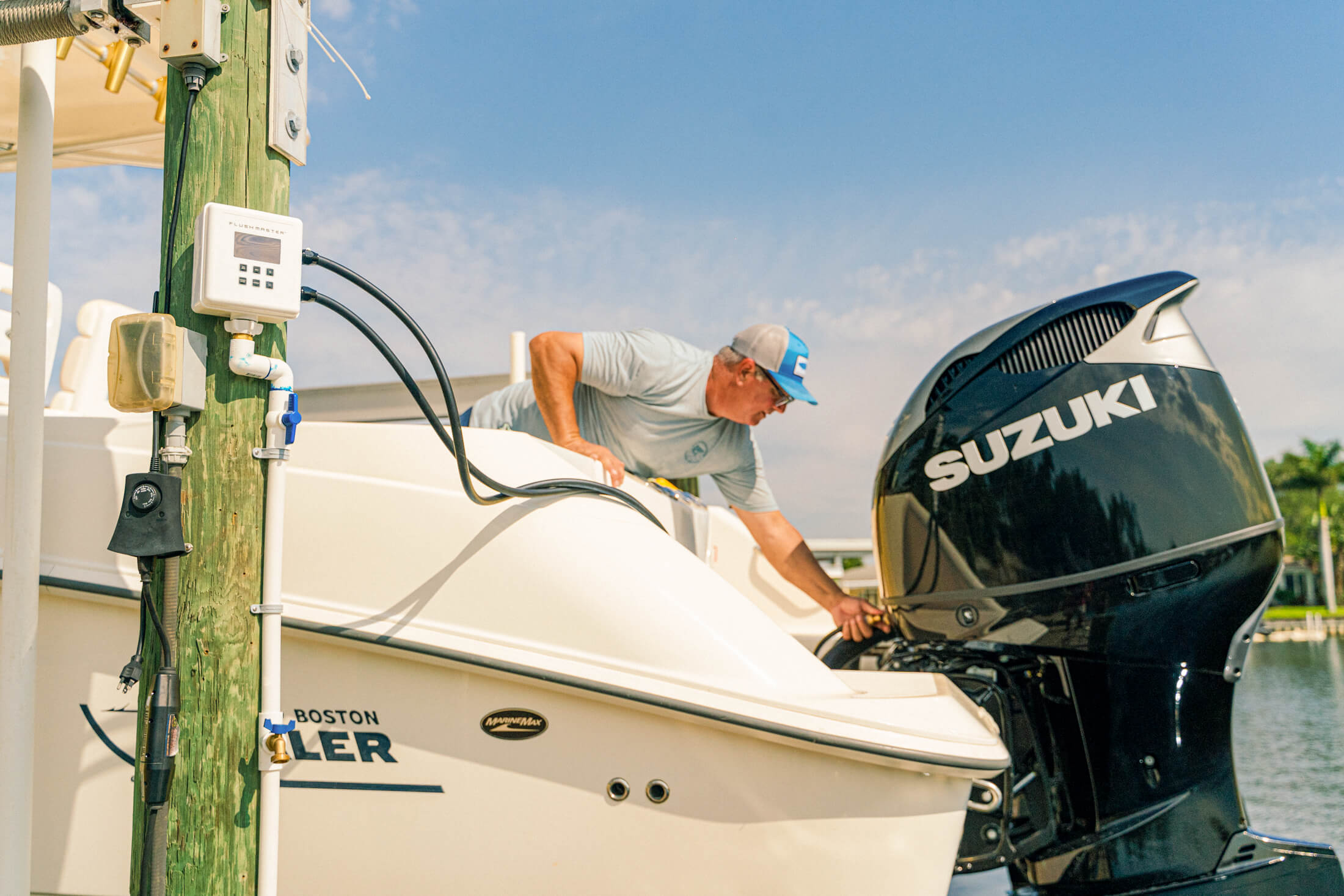 man inspecting his Suzuki boat engine