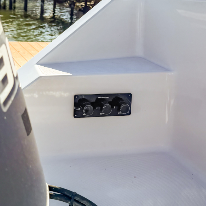 Black acrylic triple outlet flush port reroute plate on white boat with triple yamaha outboards