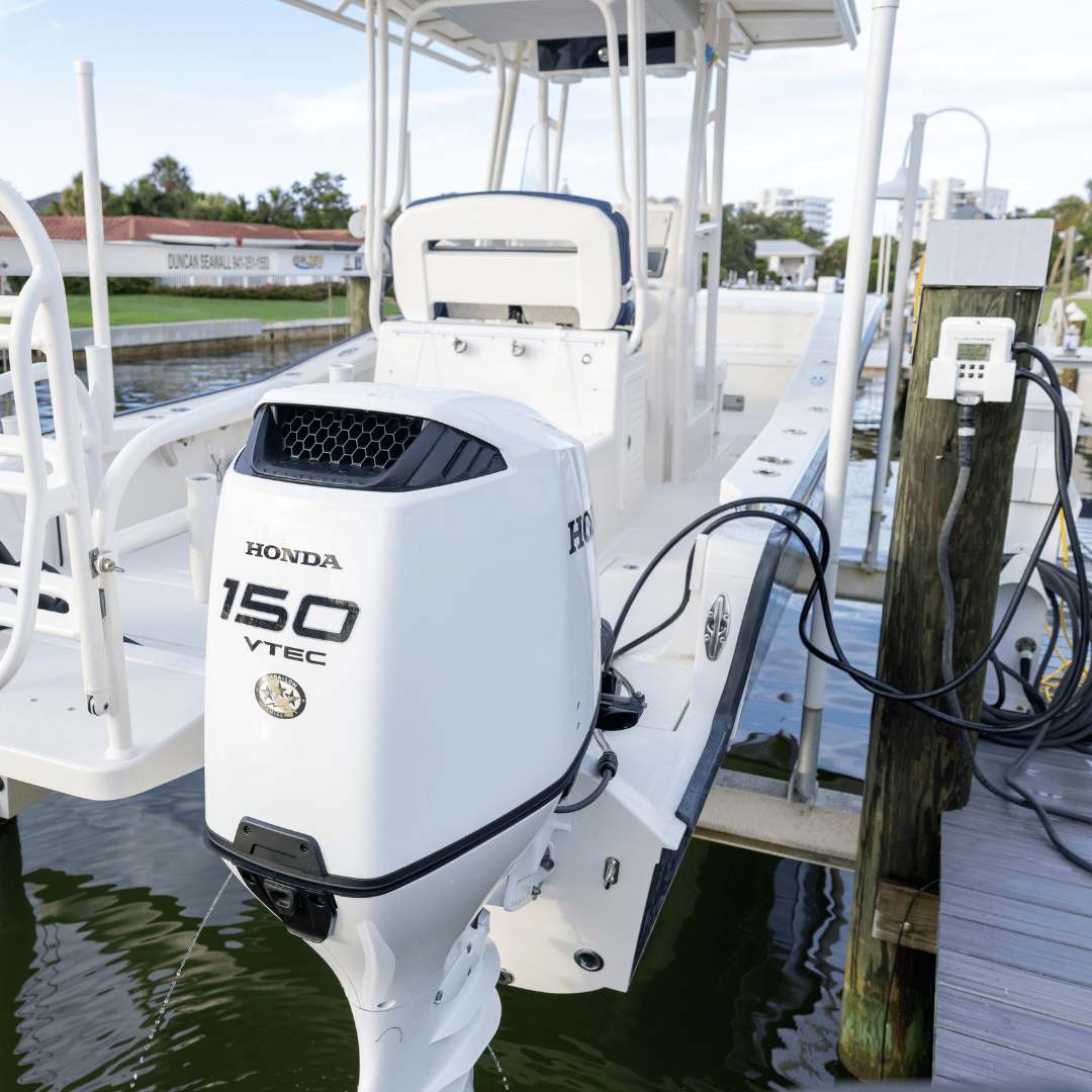 flushing twin Honda outboards on boat lift