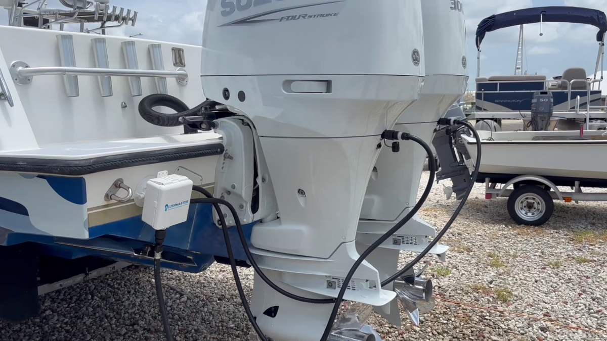 Shown: a Controller and Suncover beside Suzuki outboards, with hoses connected at the engines.
