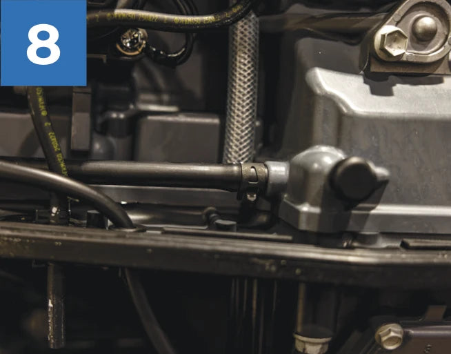 The existing flush line inside the engine cowling on this example installation.