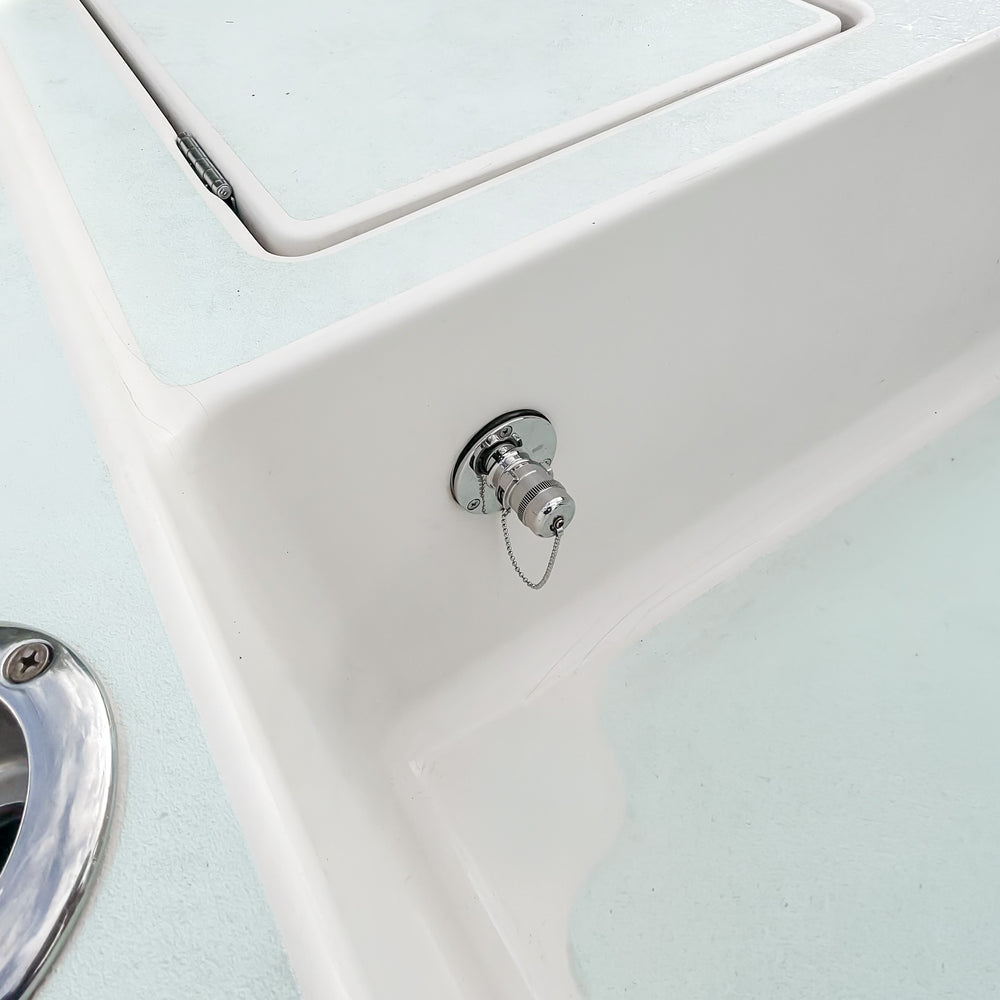 Quick Connect Water Inlet installed on a white fiberglass boat with its stainless locking cap