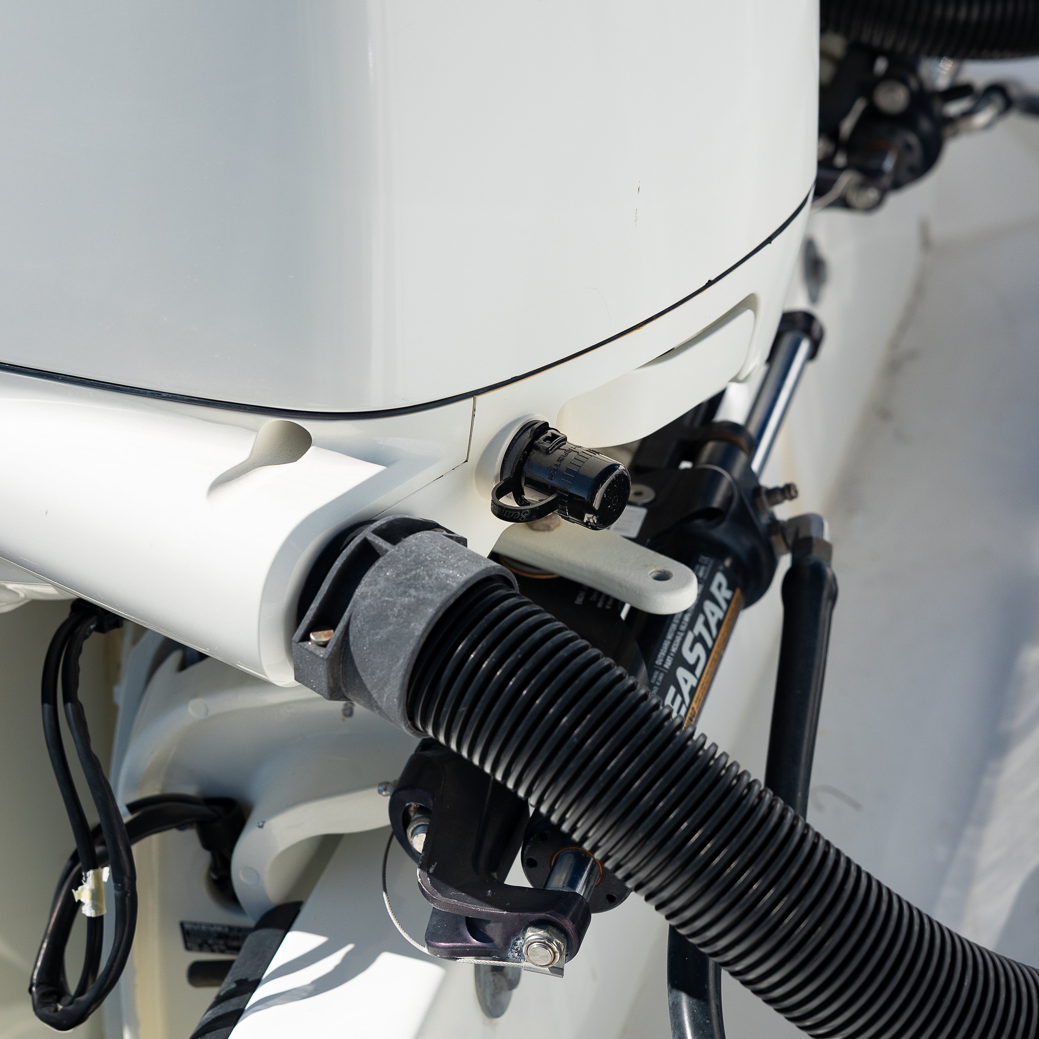 close up of flush port quick connect for suzuki on white engine