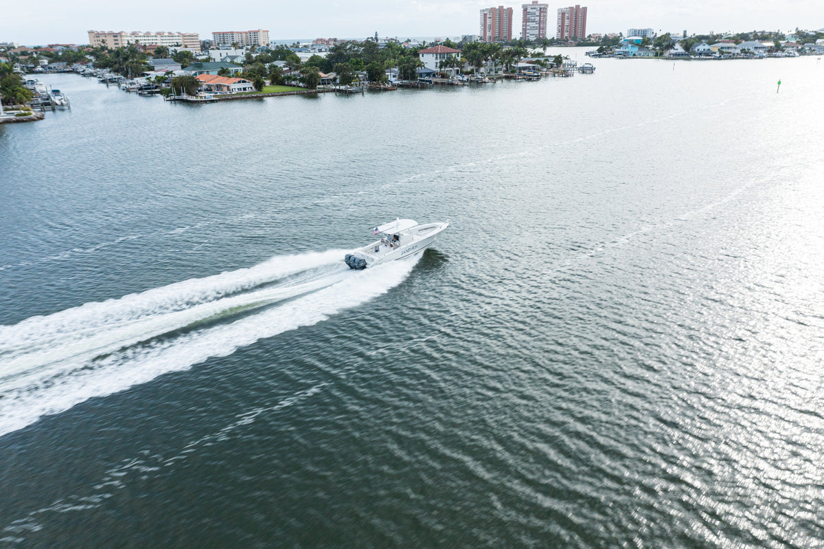 Aerial view of a motorboat making a turn on open water
