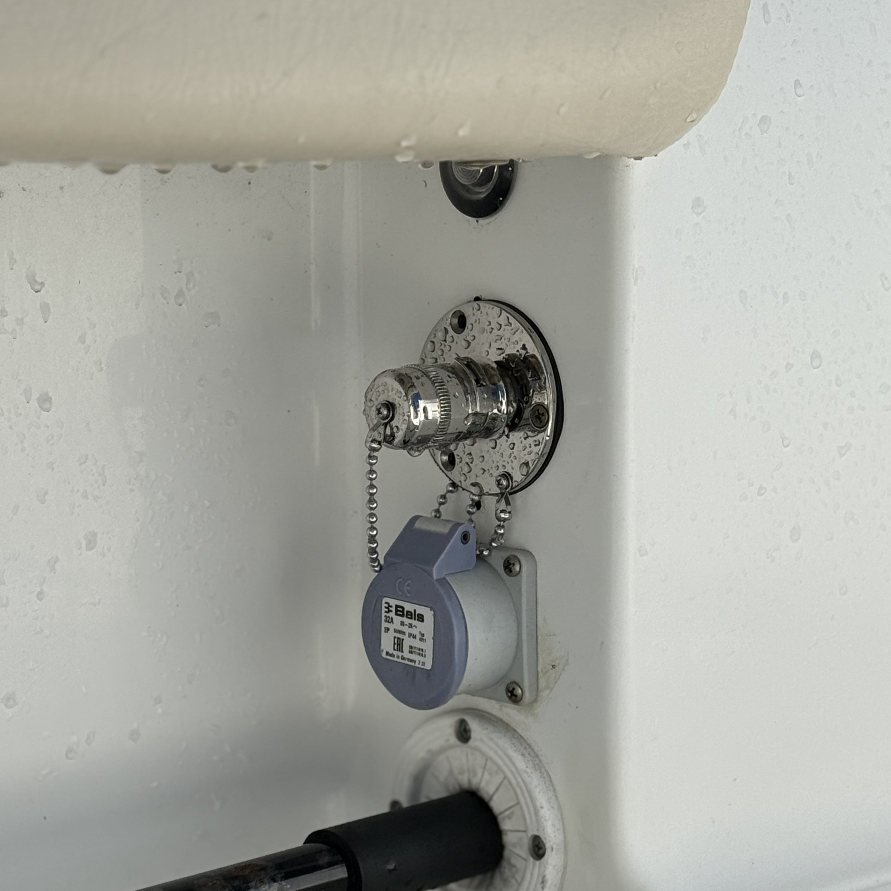 close up of water inlet outlet quick connect fitting on fiberglass boat