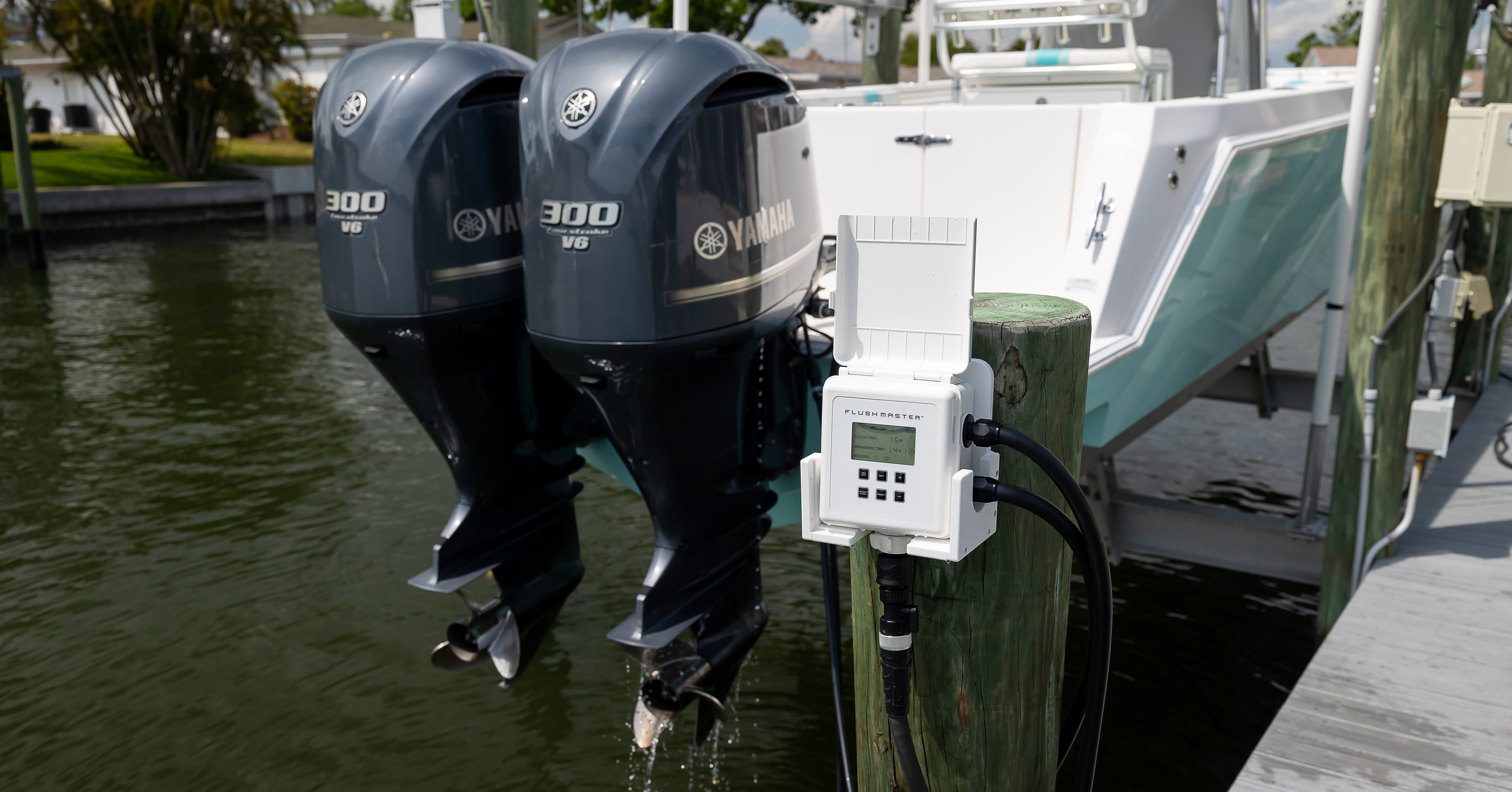 flushing dual yamaha outboards with flushmaster housed in cradle mounted on dock piling