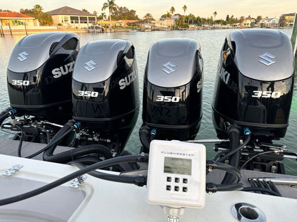 Flushing quad Suzuki outboards with Flushmaster system, ensuring optimal engine performance.