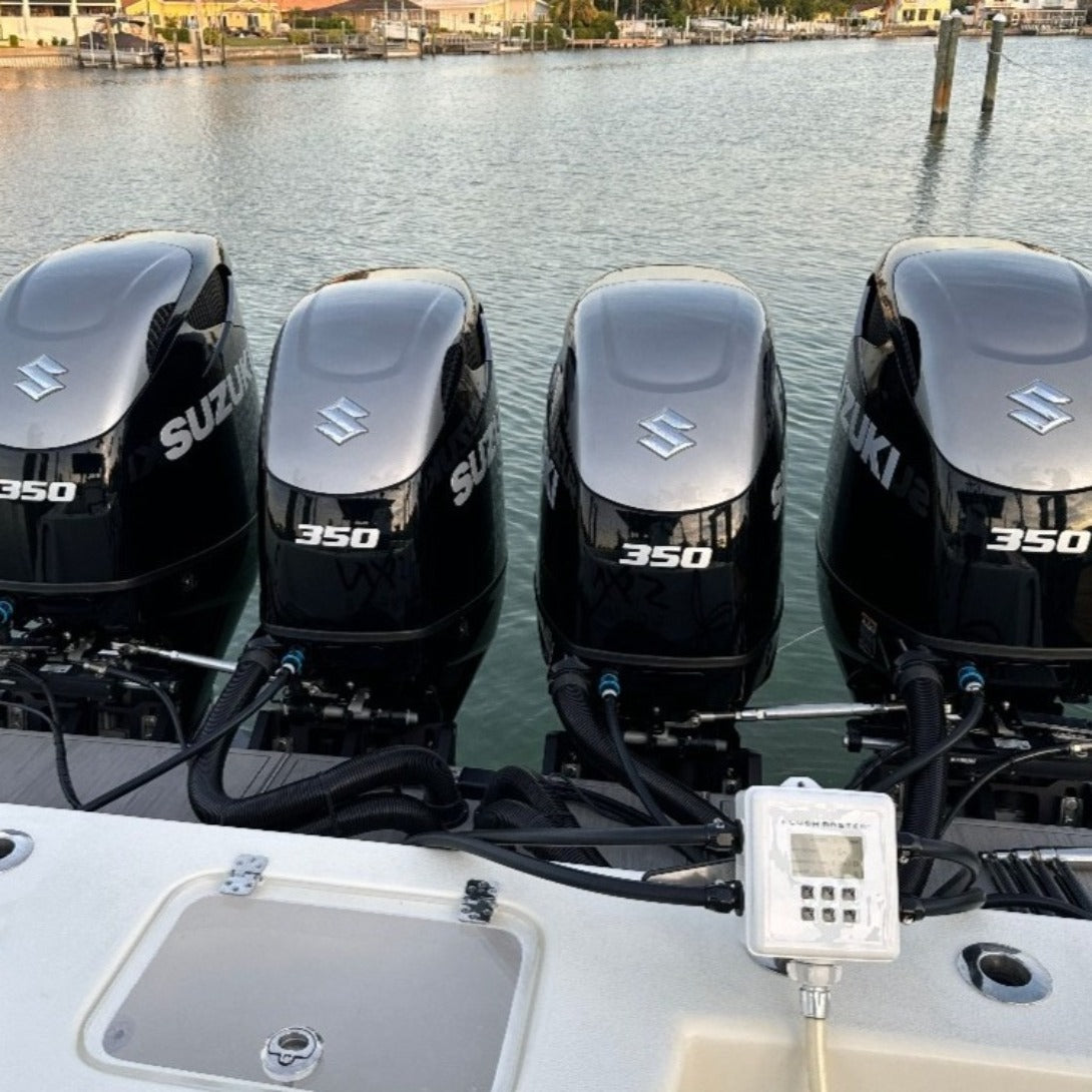 Aerial view of Flushmaster system efficiently flushing quad Suzuki outboard engines on a large vessel, demonstrating its capacity for simultaneous multi-engine maintenance.