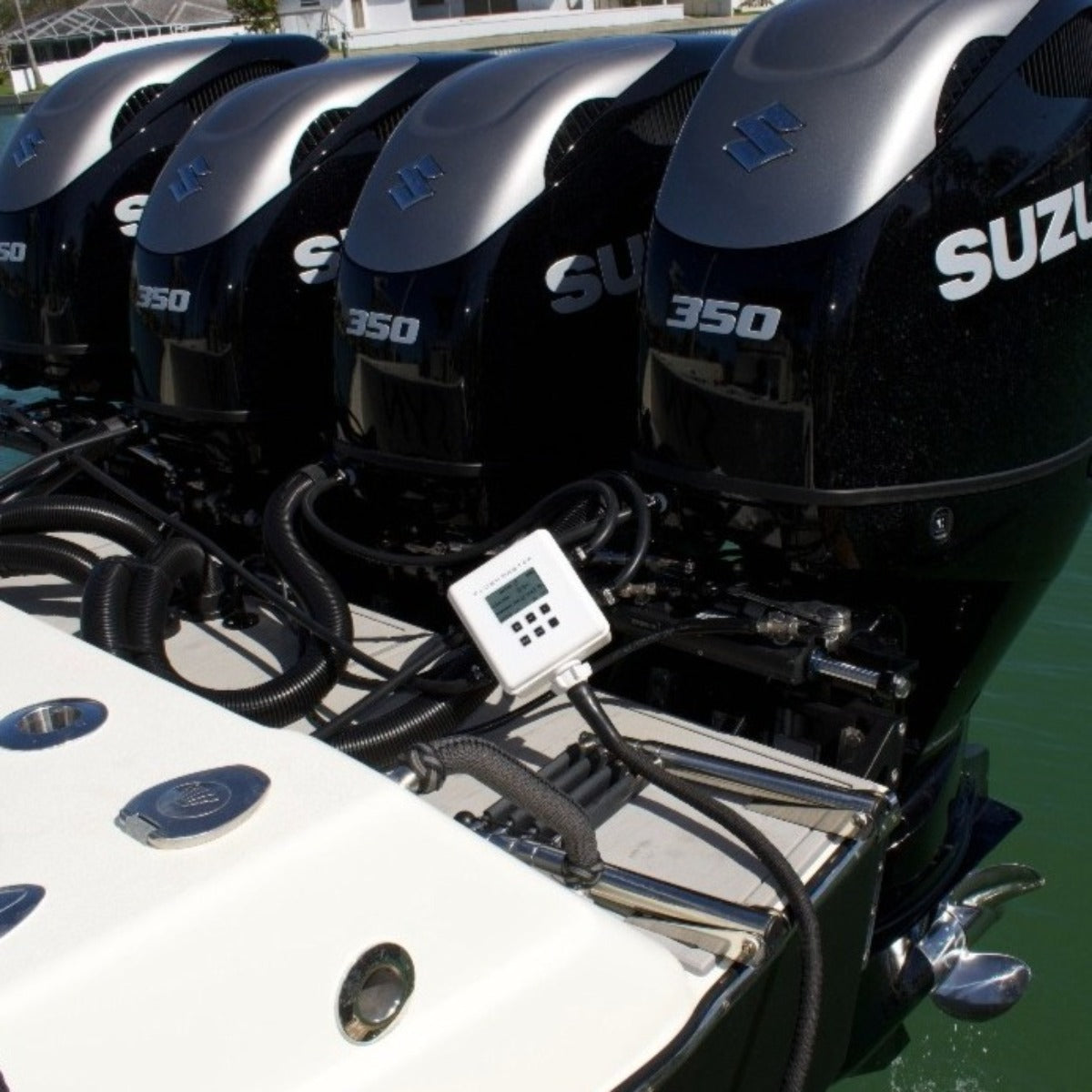 Flushmaster outboard motor flusher connected to quad Suzuki motors for efficient engine maintenance.