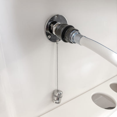 hose connected to quick connect water fitting with cap hanging