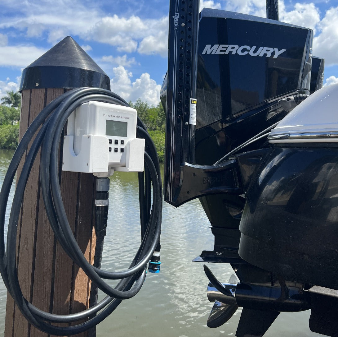 Flushmaster system securely mounted in its cradle on a dock, facilitating efficient boat engine flushing directly from the waterfront.