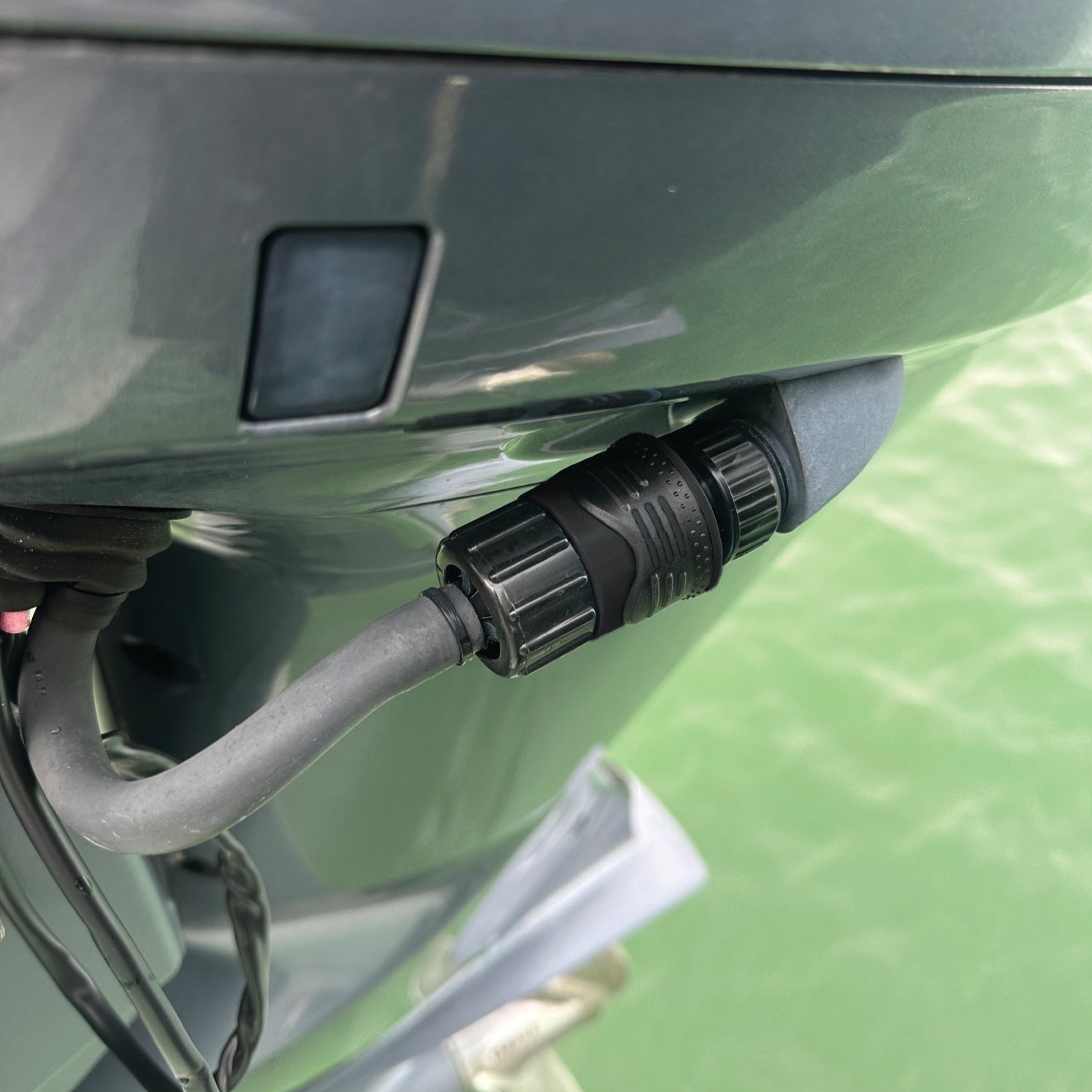 Close-up of flush port quick connect for Yamaha outboard engines, illustrating secure attachment for effective engine flushing.