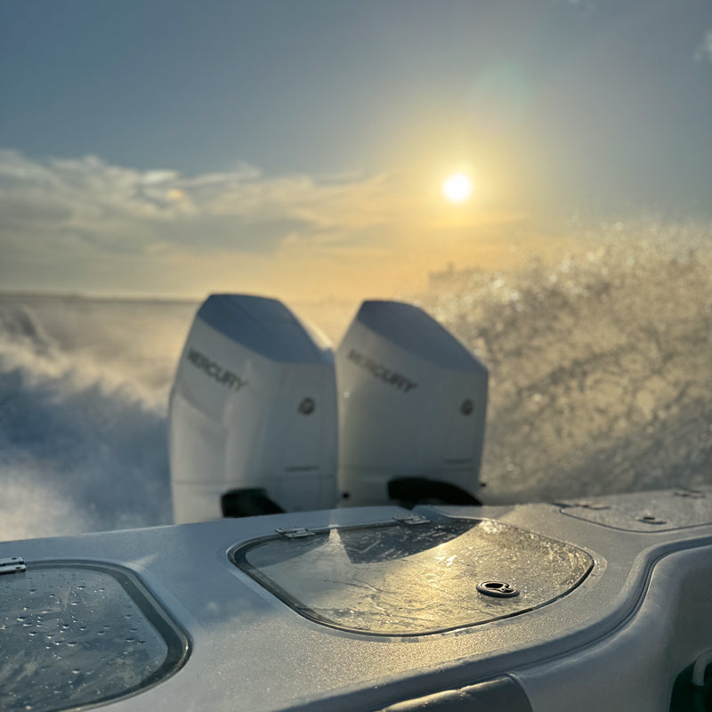 mercury boat engine running with sunset