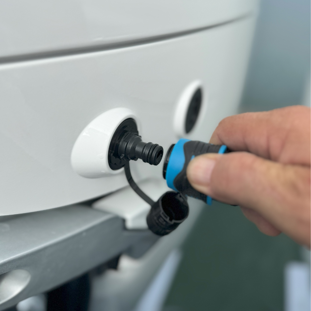 Connecting flush hose to Mercury outboard engine, showcasing secure and efficient engine maintenance.