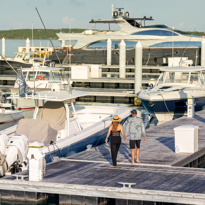couple walking away from boat together on dock