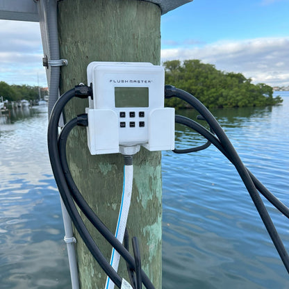 Flushmaster cradle mounted on a dock piling, providing a secure and accessible setup for marine engine flushing.