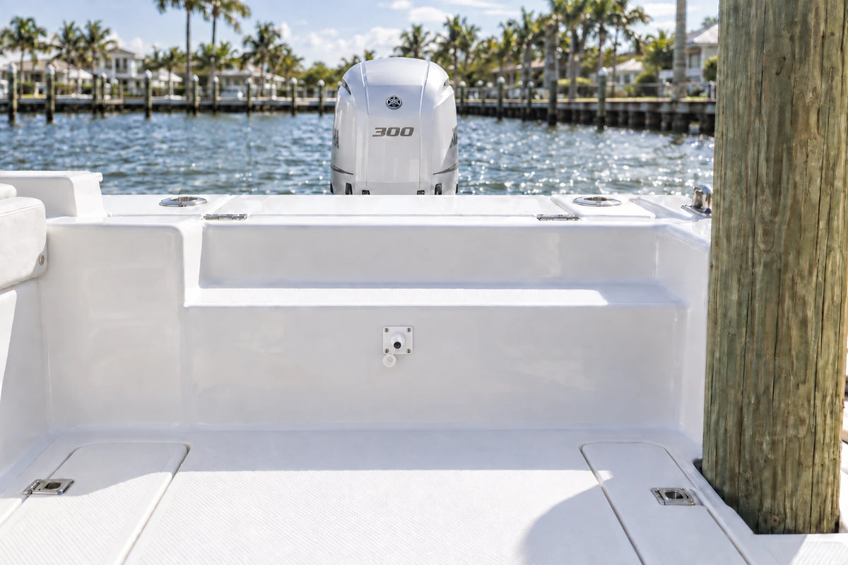 Illustrated white 1-outlet Flush Port Reroute mounted horizontally in a boat cockpit with 1 outboard engine and open locking caps