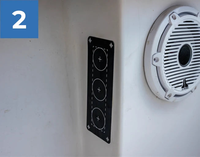 Reroute mounting template positioned on the inside wall of the boat.