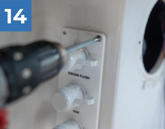 Securing the white Reroute plate to the boat with a screwdriver