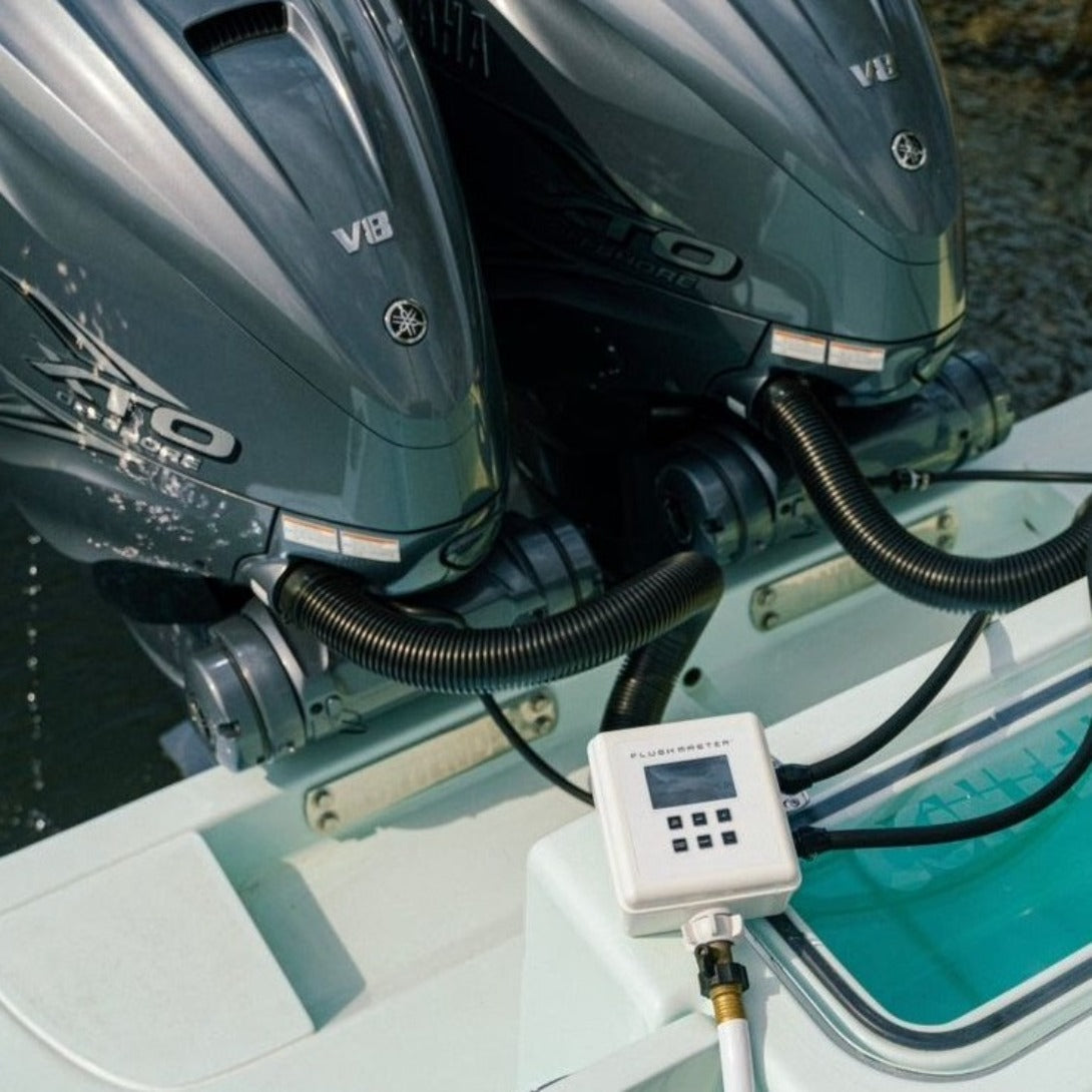 Flushmaster system actively flushing dual Yamaha outboard engines on a Contender boat, showcasing efficient saltwater flushing and engine maintenance at a dock.