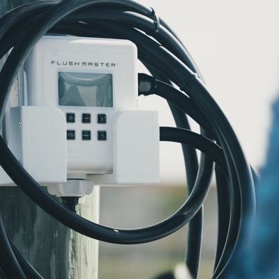 man connecting water source to flushmaster controller