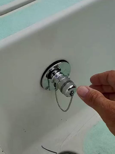 hand removing and connecting 316 SS metal cap off 316 ss metal quick connect water fitting installed on white boat fiberglass