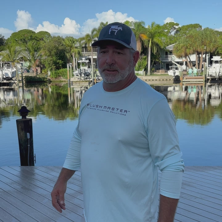 Flushmaster presenter discussing outboard flushing beside a boat
