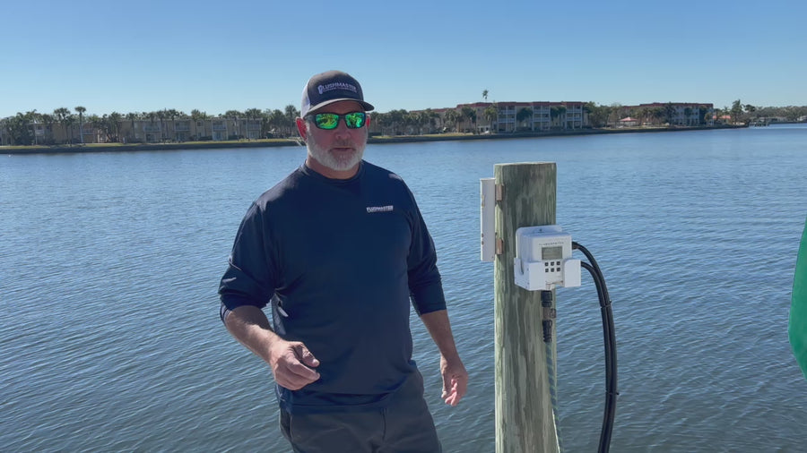 Presenter discussing outboard flushing beside a dock-mounted Flushmaster Controller