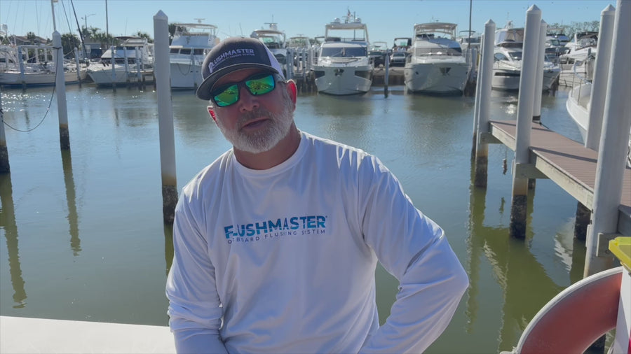 Flushmaster product discussion filmed beside boats at a marina